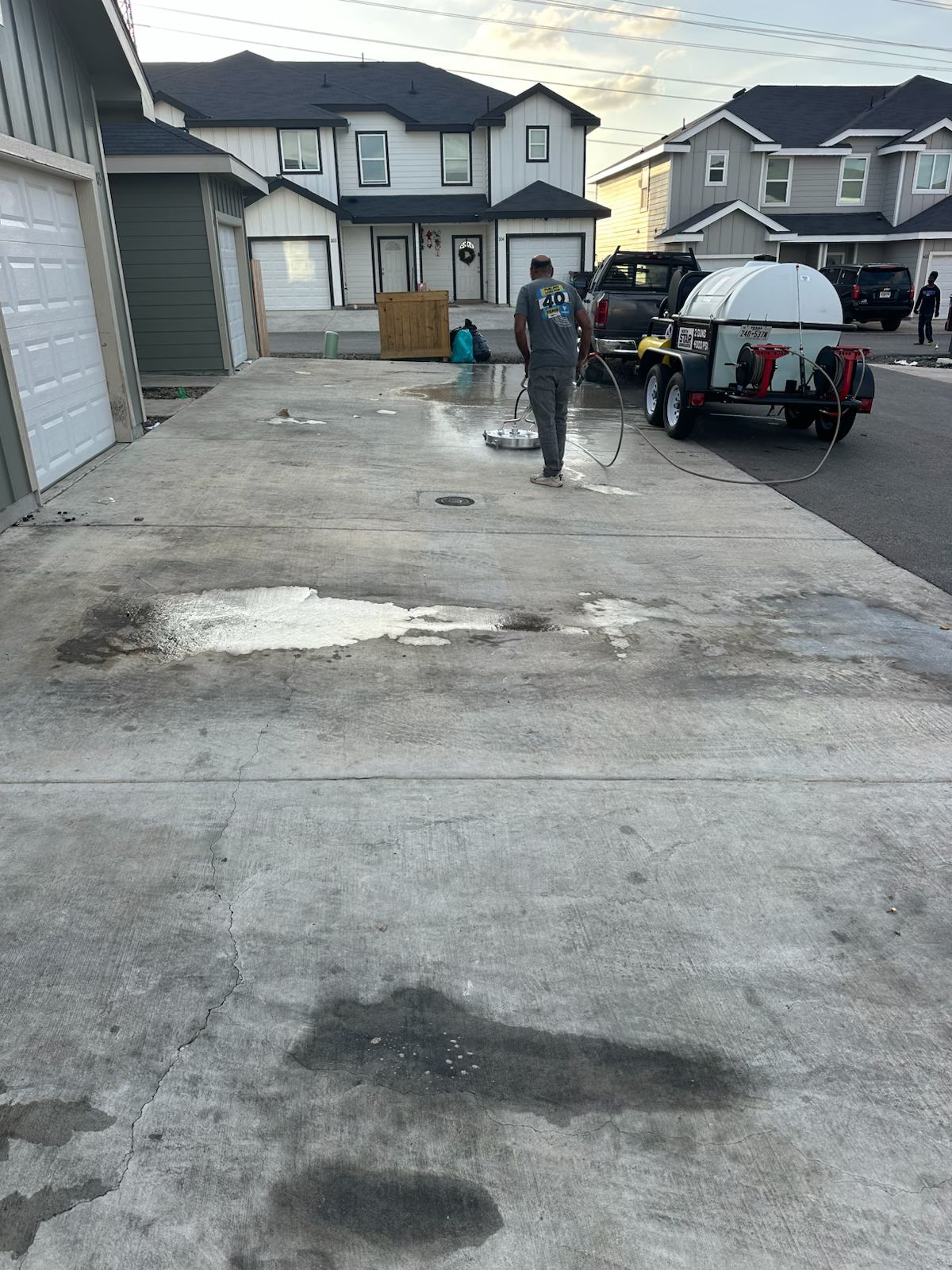 Pressure washing driveway in progress